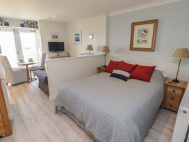 A bedroom with a bed, seating area and table at The Bolthole in Newport