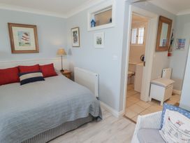 A bedroom with a bed and adjoining bathroom at The Bolthole in Newport
