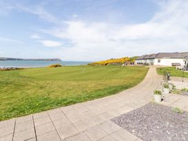 An outdoor view with a pathway and buildings by the seaside at The Bolthole in Newport
