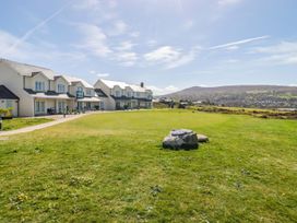 A view of houses with a grassy area and mountains in the background at The Bolthole in Newport