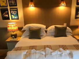 A bedroom with a double bed and bedside lamps at The Bothy at Lewis Cottage in Spreyton