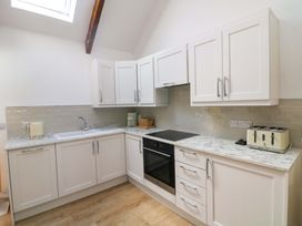 A kitchen with a sink, oven, and cabinets at The Mews @ Derrybawn, Laragh, County Wicklow