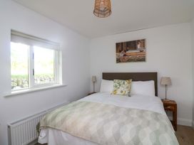 A bedroom with a bed and window at The Mews @ Derrybawn, Laragh, County Wicklow