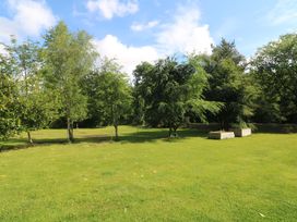 A garden with trees and planters at The Mews @ Derrybawn, Laragh, County Wicklow