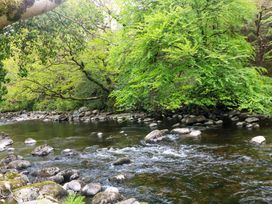 A river with rocks and trees at The Mews @ Derrybawn Laragh, County Wicklow