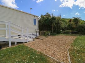 A garden with steps leading to a mobile home at Swanny View in Swanage