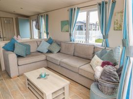 A living room with a sofa and coffee table at Swanny View in Swanage