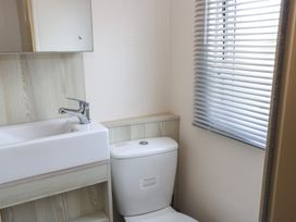 A bathroom with a sink and toilet at Swanny View in Swanage