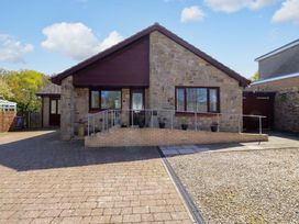 A house with a driveway and steps at Willow cottage in Seahouses