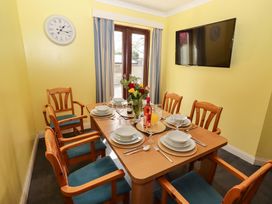 A dining room with a table set for dining at Willow cottage in Seahouses