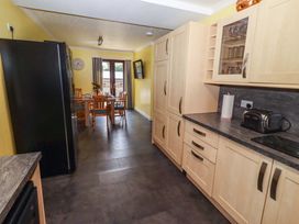 A kitchen with a dining table and chairs at Willow cottage in Seahouses