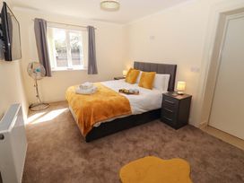 A bedroom with a double bed and bedside tables at Willow cottage in Seahouses