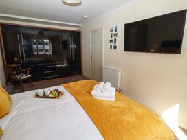 A bedroom with a bed and wardrobe at Willow cottage in Seahouses