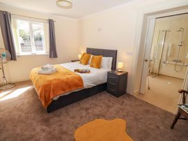 A bedroom with a bed and ensuite bathroom at Willow cottage, Seahouses