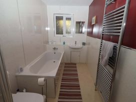 A bathroom with a bath tub and sink at Willow cottage in Seahouses