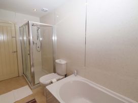 A bathroom with a shower and bathtub at Willow cottage Seahouses
