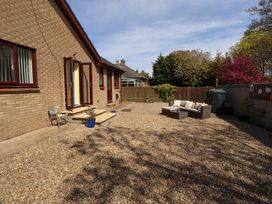An outdoor space with gravel and seating at Willow cottage Seahouses