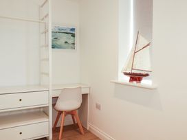 An office with a desk and model ship at Cwtch Treth in Newquay