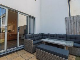 An outdoor seating area with a sofa and table at Cwtch Treth in Newquay