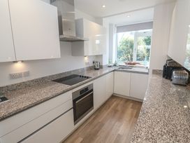 A kitchen with appliances and countertops at Cwtch Treth in Newquay