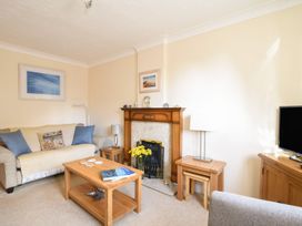 A living room with a sofa and coffee table at Mead Cottage in Bridport