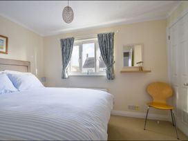 A bedroom with a bed and window at Mead Cottage Bridport