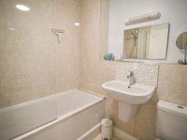 A bathroom with a shower and bathtub at Mead Cottage in Bridport