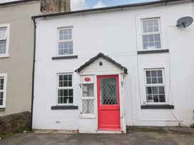 An exterior view of a house with a red door at The Old Post Office in Whitehaven