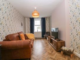 A living room with a sofa and television at The Old Post Office in Whitehaven