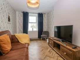 A living room with a sofa and television at The Old Post Office in Whitehaven