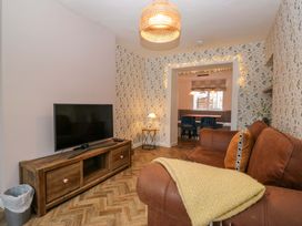 A living room with a sofa and television at The Old Post Office in Whitehaven