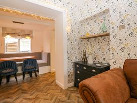 A dining room with a table and bench at The Old Post Office in Whitehaven
