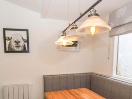 A dining area with a table and light fixtures at The Old Post Office in Whitehaven