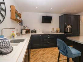 A kitchen with cabinets and appliances at The Old Post Office in Whitehaven