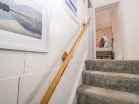 Stairs with a handrail and pictures on the wall at The Old Post Office in Whitehaven