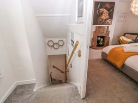 A staircase leading to a bedroom with a sofa and fireplace at The Old Post Office in Whitehaven