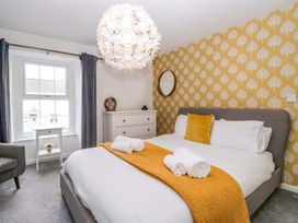 A bedroom with a bed and furniture at The Old Post Office in Whitehaven