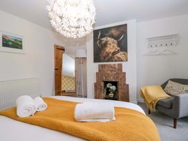 A bedroom with a bed and towels at The Old Post Office in Whitehaven