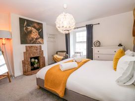 A bedroom with a bed and decorative items at The Old Post Office in Whitehaven