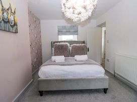 A bedroom with a bed and decorative elements at The Old Post Office in Whitehaven