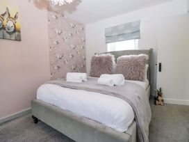 A bedroom with a bed and wall art at The Old Post Office in Whitehaven