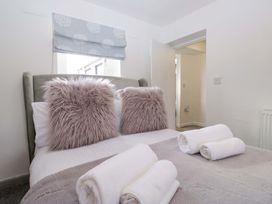 A bedroom with a bed and pillows at The Old Post Office in Whitehaven