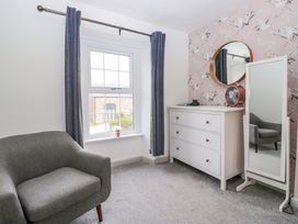 A bedroom with a window and a dresser at The Old Post Office in Whitehaven