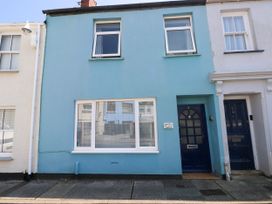 A building exterior with a blue wall and front door at 3 Edward Street Tenby