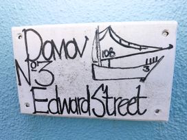 A nameplate displaying a boat drawing and address at 3 Edward Street, Tenby