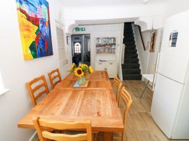 A dining room with a table and chairs at 3 Edward Street Tenby
