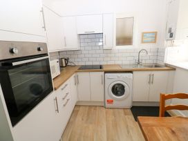 A kitchen with appliances and storage at 3 Edward Street Tenby