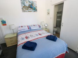 A bedroom with a bed and bedside table at 3 Edward Street Tenby