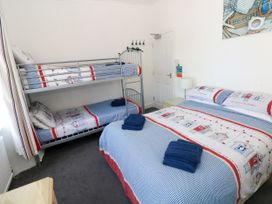 A bedroom with bunk bed and double bed at 3 Edward Street Tenby