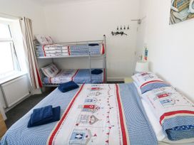 A bedroom with a bunk bed and a double bed at 3 Edward Street Tenby